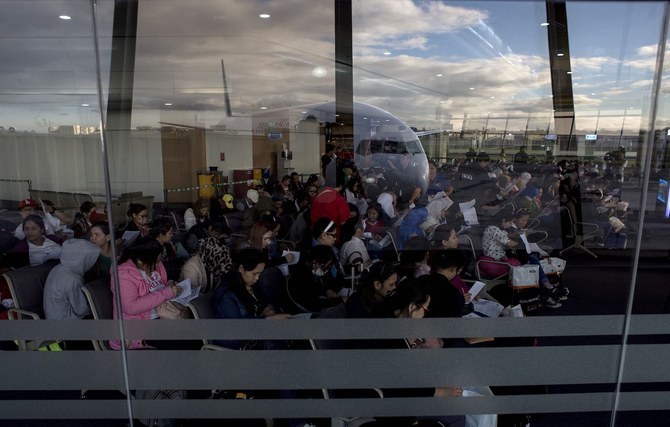 Filipino workers returning home from Kuwait arrive at Manila International Airport. (AFP/File)