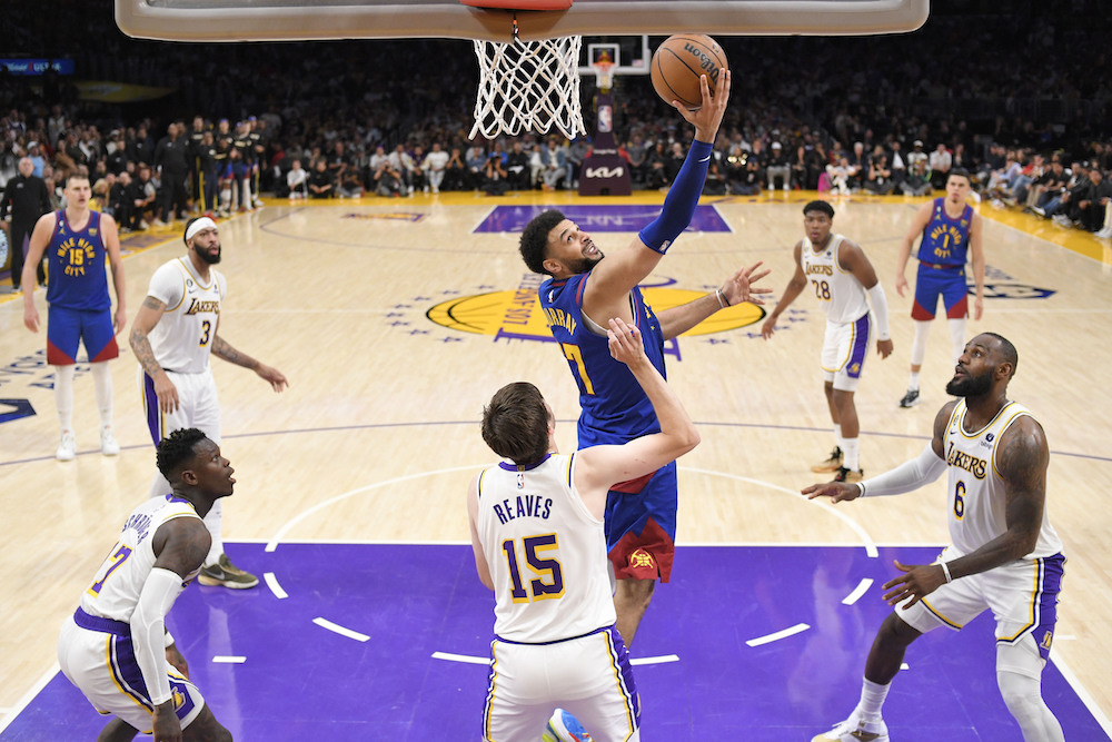 Denver Nuggets guard Jamal Murray, top, shoots over Los Angeles Lakers guard Austin Reaves (15) in the second half of Game 3 of the NBA Western Conference Final series Saturday in Los Angeles. (AP)