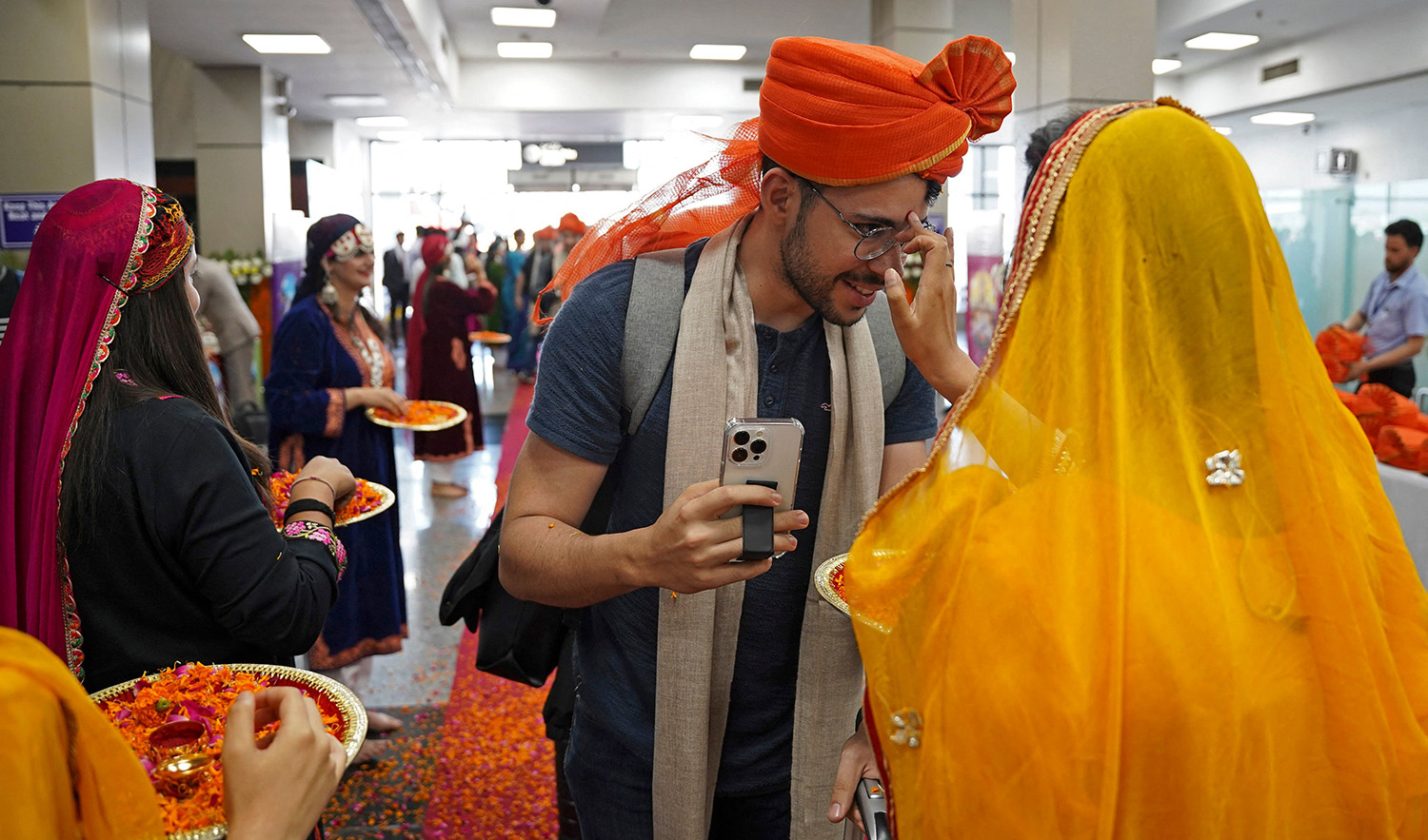 A G20 foreign delegate, center, is traditionally welcomed upon his arrival at the airport in Srinagar, India, on May 22, 2023. (AP)