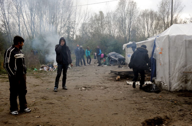 Illegal migrants are pictured in their makeshift camp where 200 migrants, many of whom were Iraqis, Afghans or Vietnamese are living on November 18, 2010 in Teteghem near Dunkirk, northern France. (AFP)