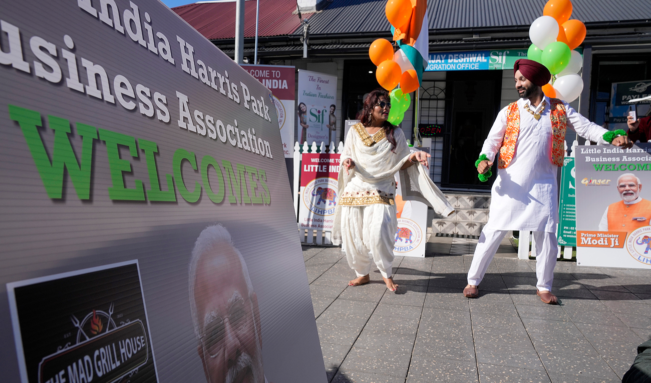 People dance in the street as they wait hoping Indian Prime Minister Narendra Modi might visit the suburb of Harris Park in Sydney, Tuesday, May 23, 2023. (Photo courtesy: AP)