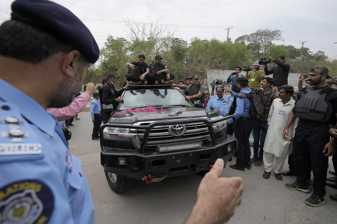 Pakistan’s former Prime Minister Imran Khan, aboard a heavily secured vehicle, arrives to appear in a court, in Islamabad on May 23, 2023. (AP)