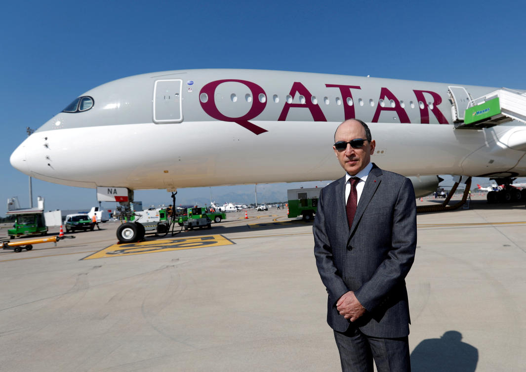 Qatar Airways Chief Executive Officer Akbar al-Baker poses in front of an Airbus A350-1000 at the Eurasia Airshow. (Reuters)
