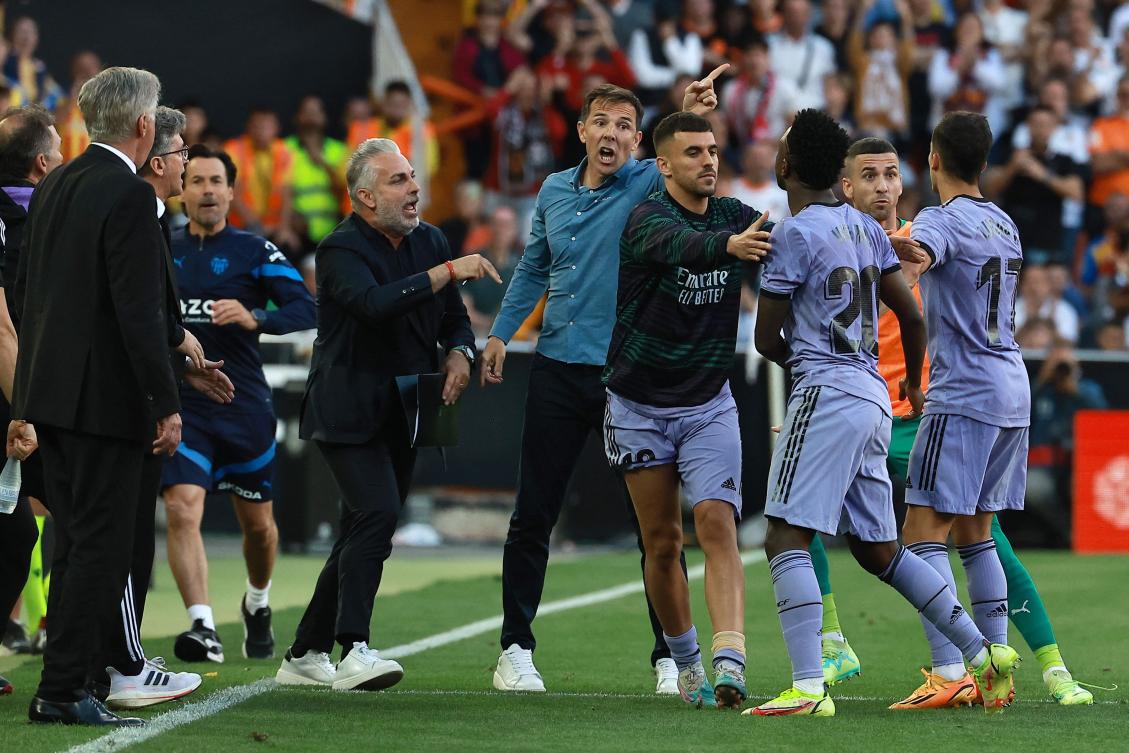 Real Madrid’s Brazilian forward Vinicius Junior confronts a Valencia’s official as he leaves after being sent off the pitch by the referee during their Spanish league match at the Mestalla stadium in Valencia on May 21, 2023. (AFP)
