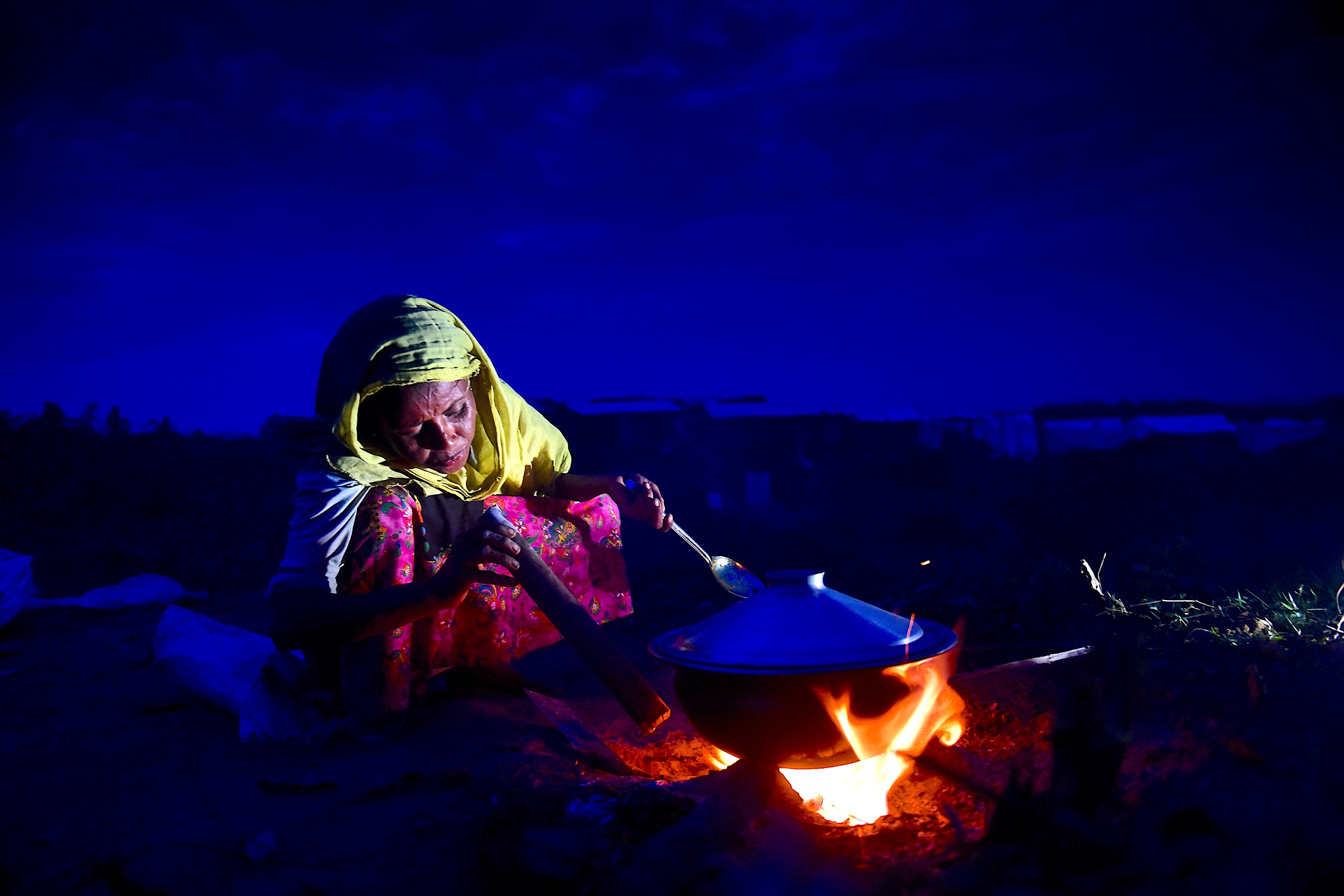 In this file photo, a Rohingya refugee woman prepares food at Hakimpara refugee camp in the Bangladeshi district of Ukhia on Nov. 15, 2017. (AFP)