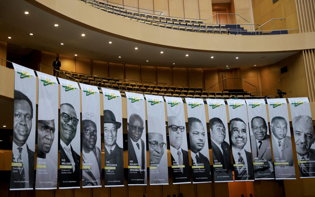 A delegate stands next to portraits of the founding heads of state of the OAU/African Union on its 60th anniversary, African Union Commission, Addis Ababa, Ethiopia, May 25, 2023. (Reuters)