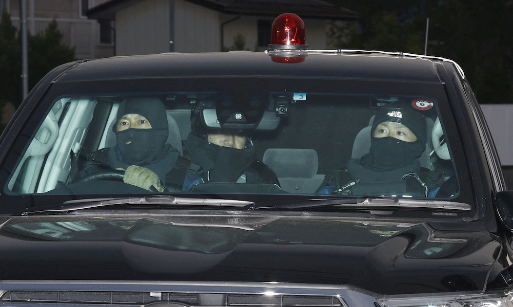 A police vehicle carrying the suspect in a knife and gun attack arrives at the Nakano Police Station in Nakano, Nagano Prefecture of central Japan on May 26, 2023. (Kyodo via Reuters)