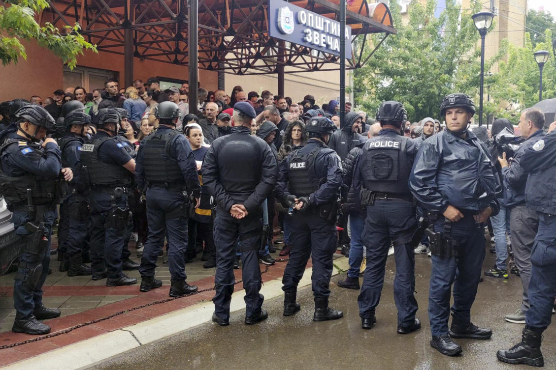 In this image made from video, Kosovar police stand guard confronting ethnic Serbs outside municipality building in Zvecan, northern Kosovo on May 26, 2023. (AP)