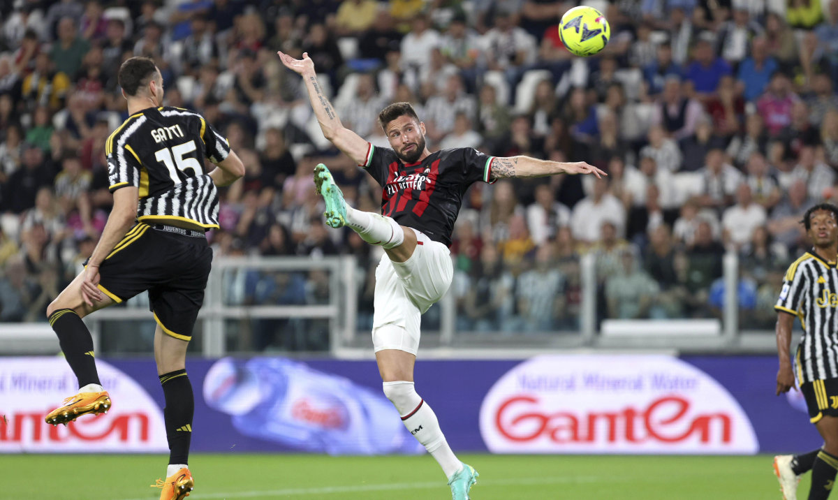 AC Milan's Olivier Giroud reaches for the ball for the ball during their Serie A match against Juventus at the Turin Allianz stadium, Italy, Sunday. Giroud scored the only goal in the match. (AP)