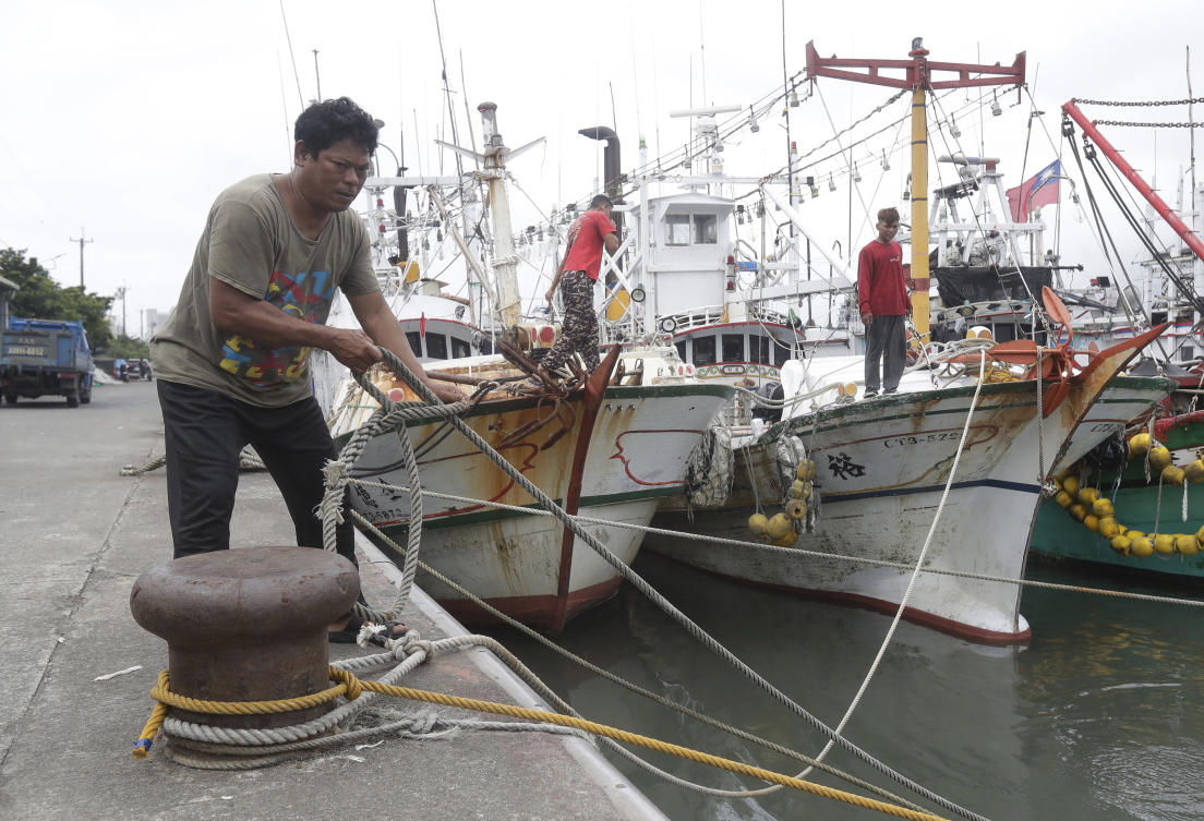 Fishermen fasten the boats as Typhoon Mawar approaches eastern Taiwan in Yilan County on May 30, 2023. (AP)