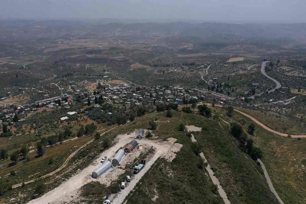 Above, an aerial view of the Israeli settler outpost of Homesh, near the Palestinian village of Burqah, in the occupied West Bank on May 29, 2023. (AFP)