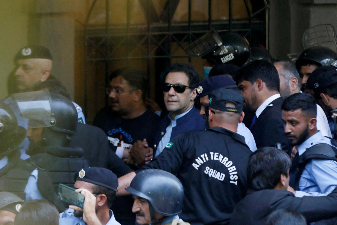 Security officers escort Pakistan’s former prime minister Imran Khan as he appears at the Islamabad High Court on May 12, 2023. The former leader is embroiled in a number of corruption cases filed against him. (Reuters)