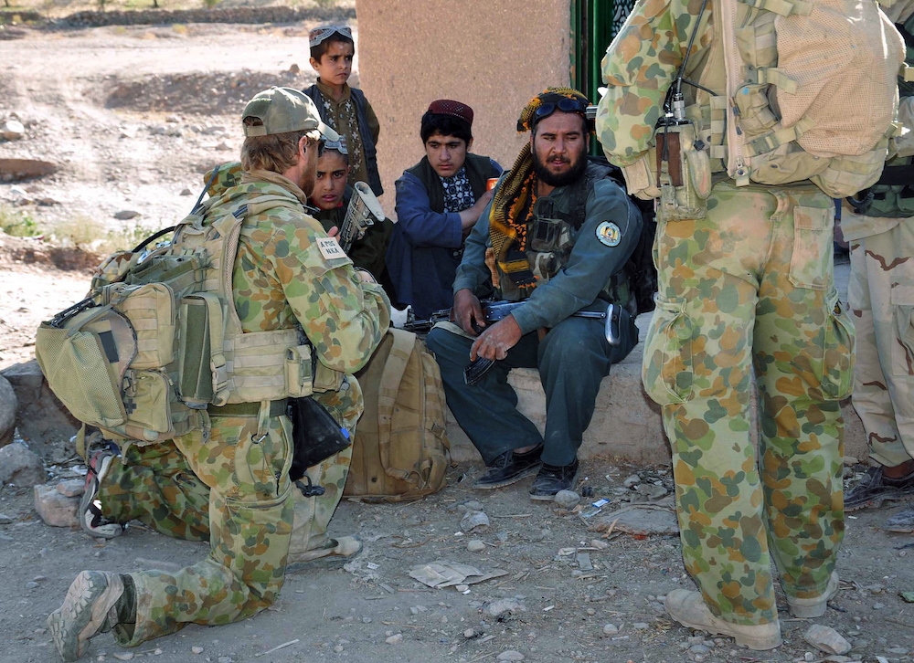 Australian soldiers from the Special Operations Task Group talk with children and an Afghan commander during a mission in southern Afghanistan on Oct. 21, 2009. (Australian Department of Defence/AFP)