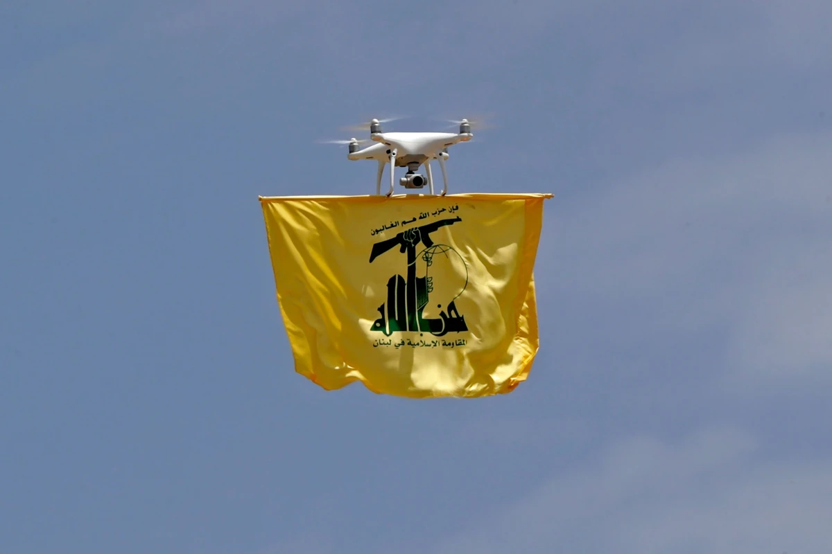A drone carries a flag of Lebanon’s Hezbollah movement above Aaramta bordering Israel on May 21, 2023 (File/AFP)
