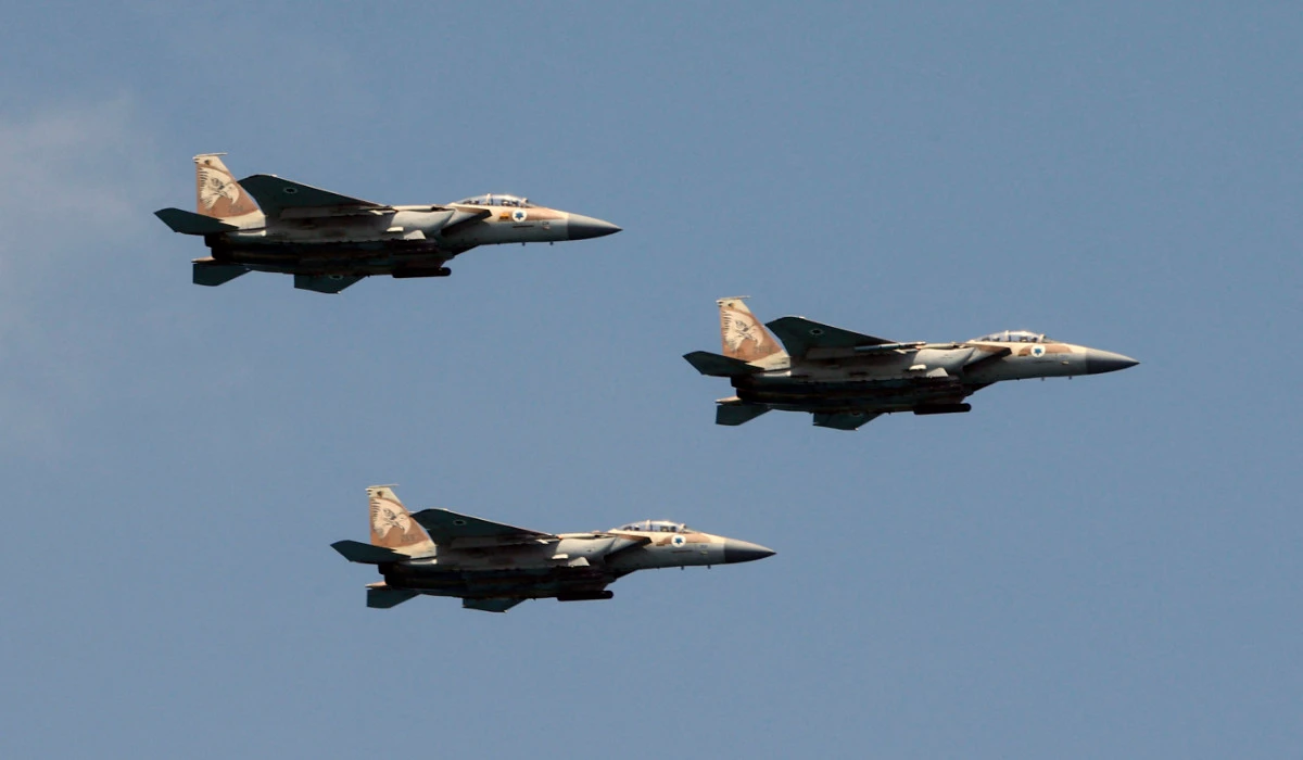 Israeli F-15 fighter jets perform during an air show over the beach in the Israeli coastal city of Tel Aviv on May 5, 2022. (AFP)