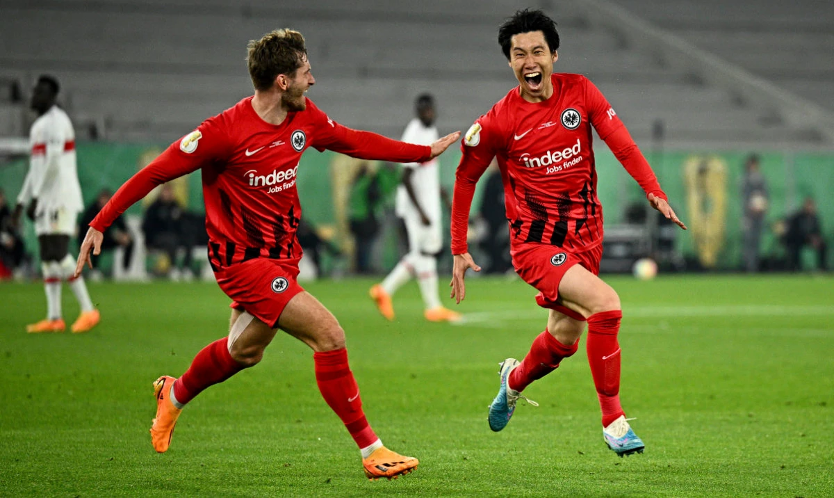 Frankfurt's Daichi Kamada celebrates his goal with Christopher Lenz during a German Soccer Cup semi-final match between VfB Stuttgart and Eintracht Frankfurt at Mercedes-Benz Arena, Stuttgart, Germany, May 3, 2023. (AP)