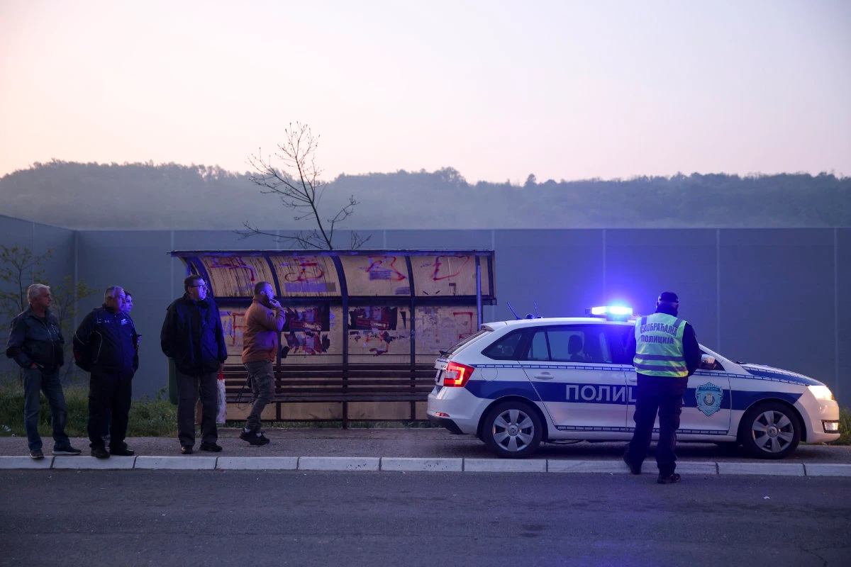 Police officers block the road near the village of Mali Pozarevac, some 50 kilometers south of Belgrade, on May 5, 2023 where a random shooting took place. (AP)