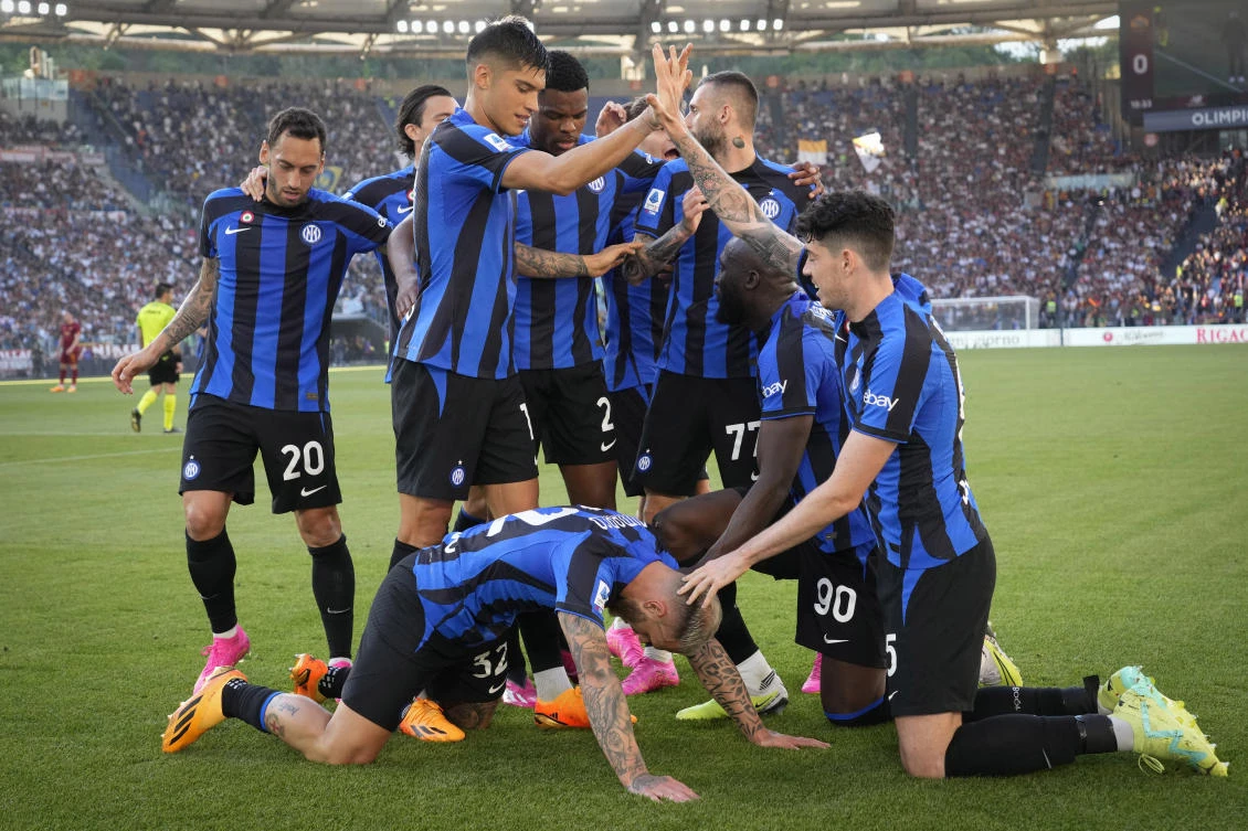 Inter Milan players celebrate after Federico Dimarco scored his side’s opening goal during their Serie A match against Roma at Rome’s Olympic Stadium, on May 6, 2023. (AP)