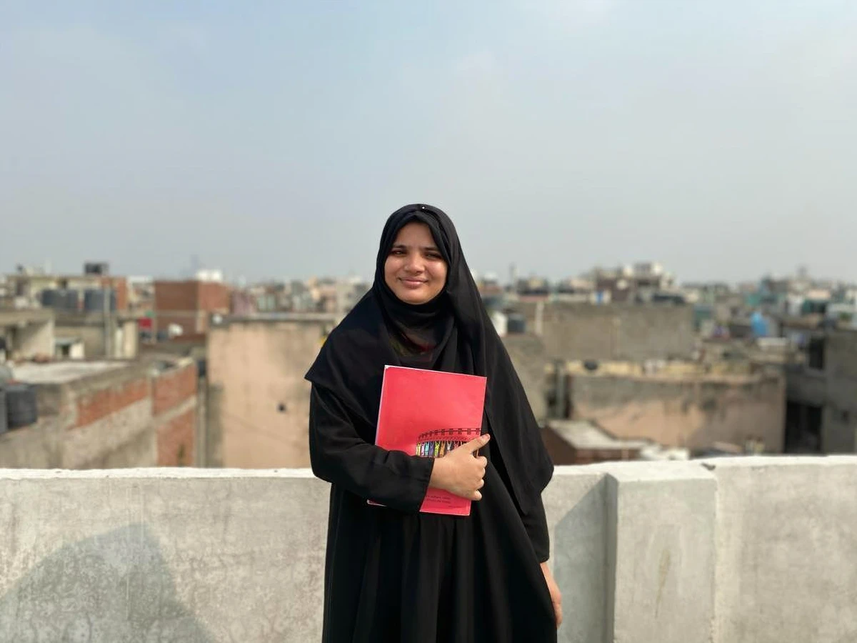 Tasmida Johar, India’s first female Rohingya graduate, poses for a photo on the rooftop of her house in New Delhi, in 2023. (Amina Khatoon)