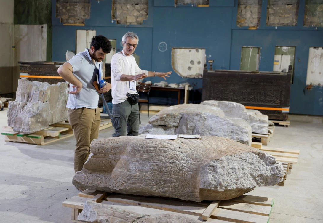 Visitors look at antiquities in the Mosul Civilization Museum after the museum was declared rehabilitated in Mosul, Iraq May 11, 2023. (Reuters)