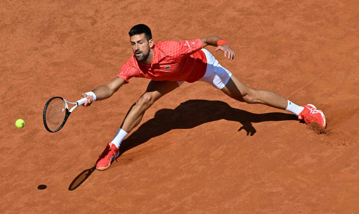 Serbia's Novak Djokovic returns to Bulgaria's Grigor Dimitrov during their third round match at the Men's ATP Rome Open tennis tournament at Foro Italico in Rome on Sunday. (AFP)