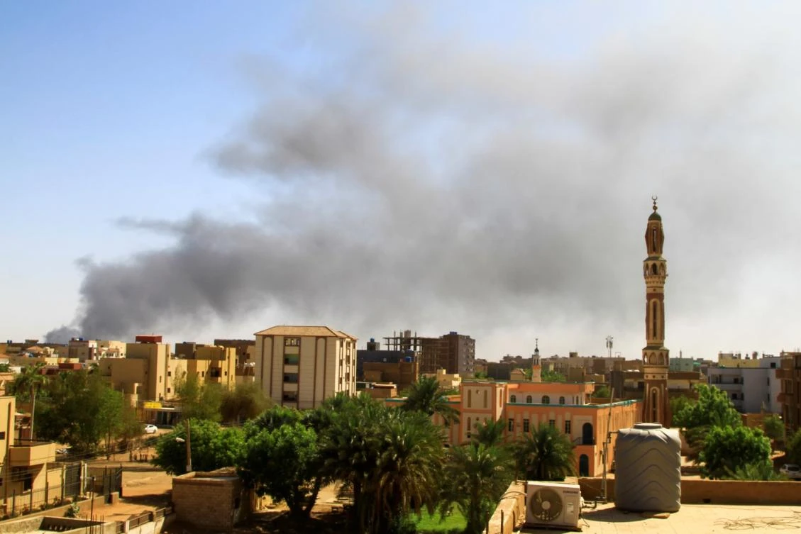 Smoke billows in the distance in Khartoum amid ongoing fighting between the forces of two rival generals (AFP)