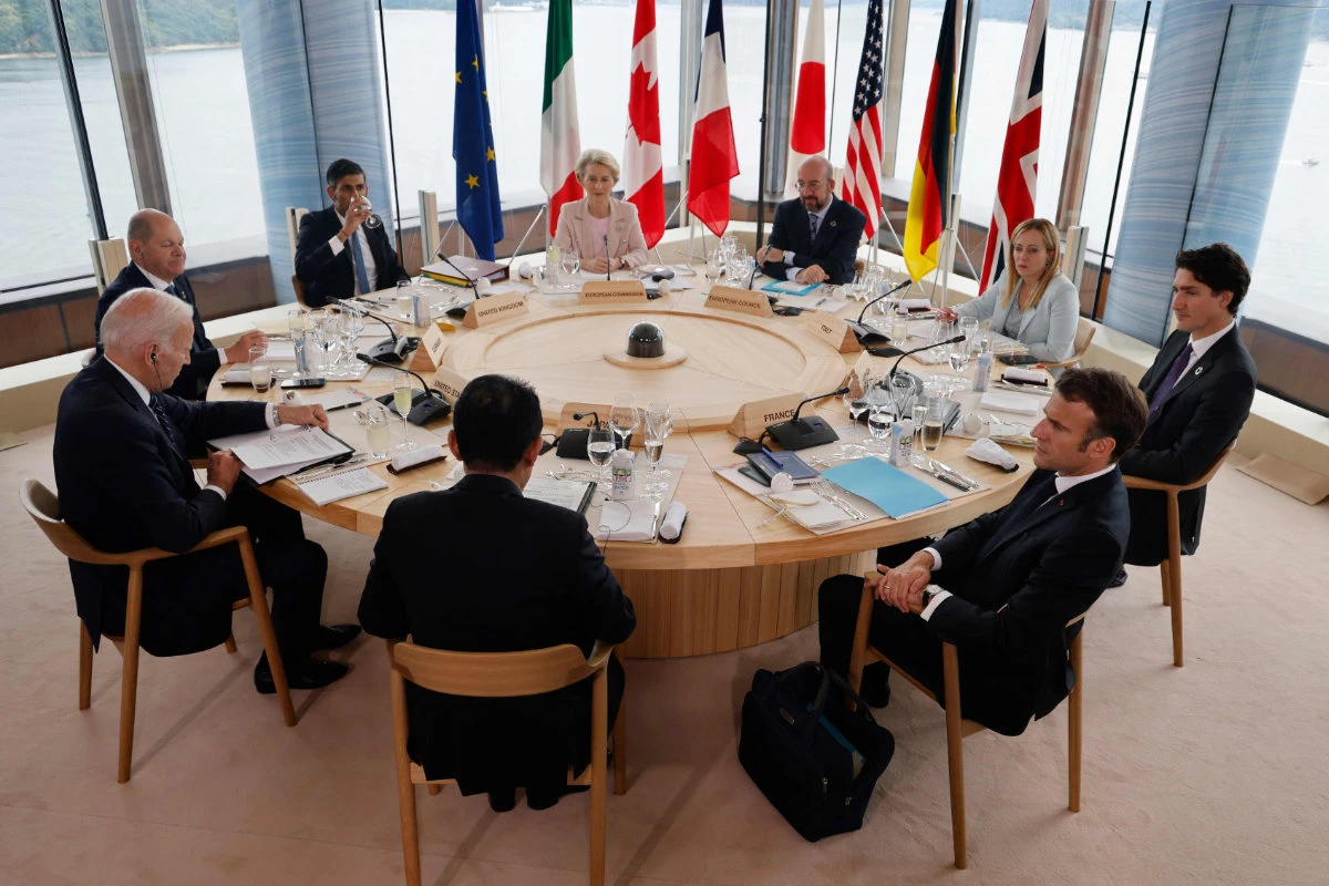 (L to R) US President Joe Biden, Germany's Chancellor Olaf Scholz, Britain's Prime Minister Rishi Sunak, Japan's Prime Minister Fumio Kishida, European Commission President Ursula von der Leyen, European Council President Charles Michel, France's President Emmanuel Macron, Italy's Prime Minister Giorgia Meloni, and Canada's Prime Minister Justin Trudeau take part in a working lunch session as part of the G7 Leaders' Summit in Hiroshima on May 19, 2023. (POOL / AFP) Hiroshima, Japan (POOL)