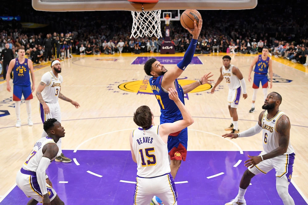 Denver Nuggets guard Jamal Murray, top, shoots over Los Angeles Lakers guard Austin Reaves (15) in the second half of Game 3 of the NBA Western Conference Final series Saturday in Los Angeles. (AP)