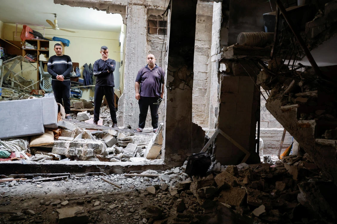 Palestinians check a house damaged during an Israeli raid, in Balata camp, Nablus, in the Israeli-occupied West Bank. (Reuters)