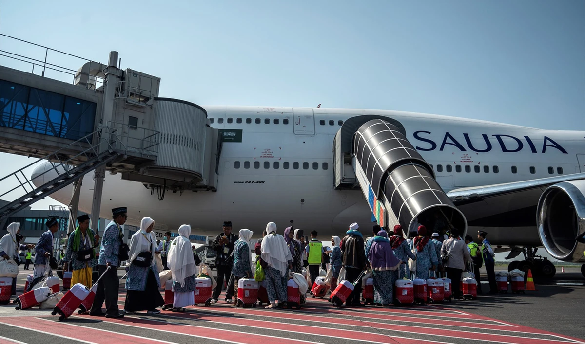 Indonesian Muslim pilgrims board a passenger plane before heading to the holy city of Makkah to perform the annual Hajj pilgrimage, at the Juanda International Airport in Sidoarjo on May 24, 2023. (AFP)