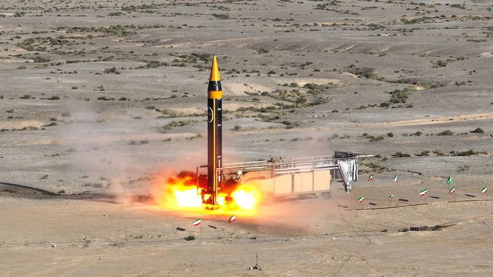 Above, the latest Khorramshahr ballistic missile, named Khaibar, launches at an undisclosed location in this photo provided by Iran’s defense ministry on May 25, 2023. (Iranian defense ministry/AFP)