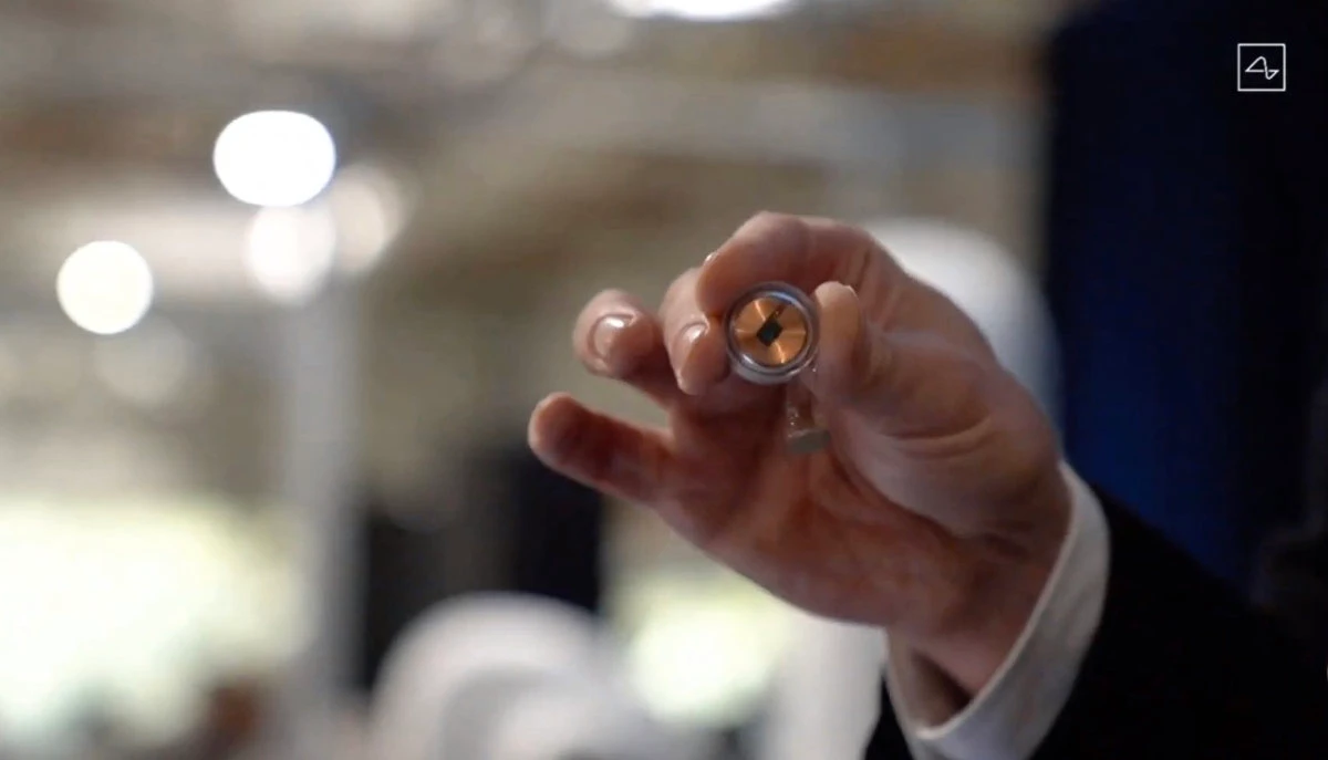 This video grab made from the online Neuralink livestream shows the Neuralink disk implant held by Elon Musk during the presentation on August 28, 2020. (Neuralink via AFP)