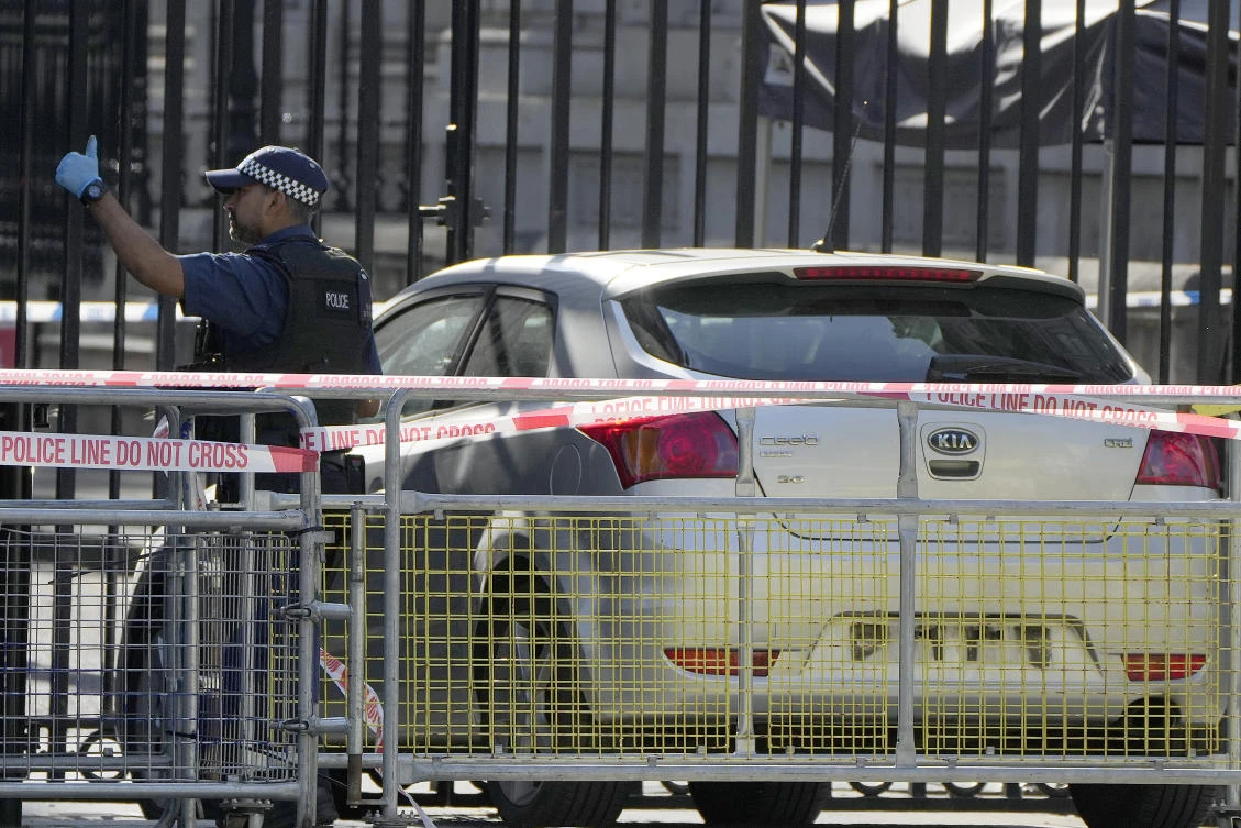 Police at the scene after a car collided with the gates of Downing Street in London on May 25, 2023. (AP)
