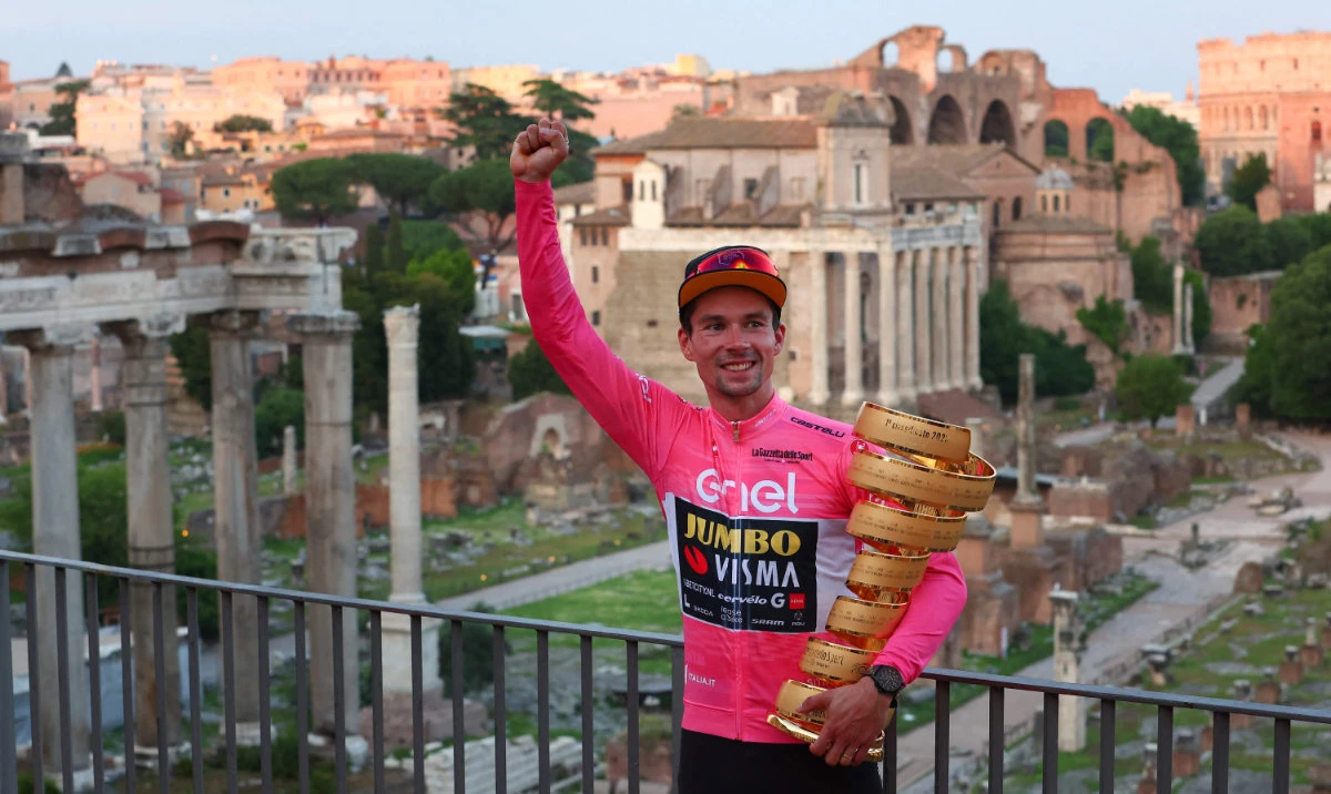 Jumbo-Visma's Slovenian rider Primoz Roglic poses by the ancient Roman Forum with the race's winner's "Trofeo Senza Fine" (Endless Trophy) after winning the Giro d'Italia 2023 cycling race on Sunday. (AFP)