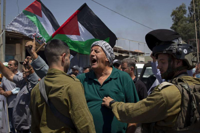 A Palestinian argues with Israeli soldiers during a protest, north of the West Bank city of Nablus. (AP/File)