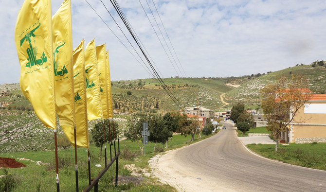 Hezbollah flags flutter at the entrance of Mays Al-Jabal village in Lebanon. (Reuters)