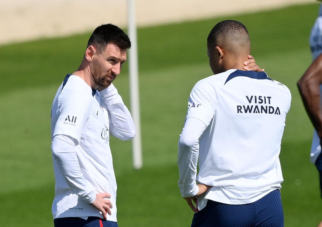 PSG’s Argentinian forward Lionel Messi speaks with French teammate Kylian Mbappe during a training session at the club’s training ground in Saint-Germain-en-Laye, Paris, on June 1, 2023. (AFP)