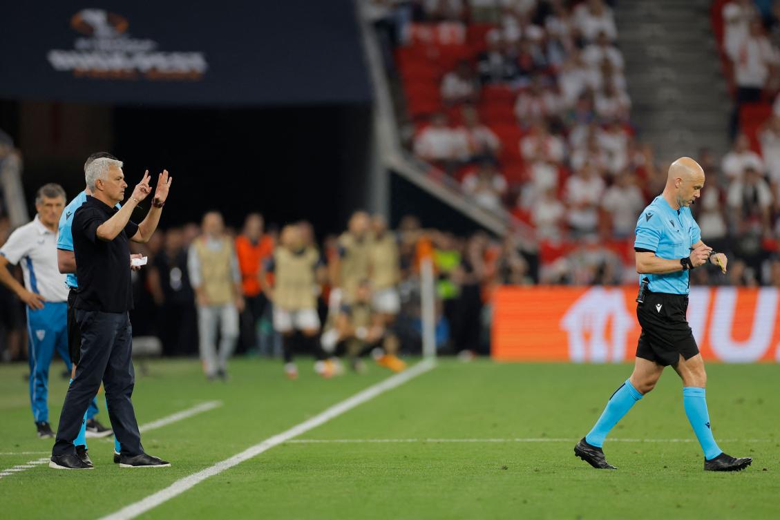 AS Roma’s Portuguese coach Jose Mourinho reacts as English referee Anthony Taylor walks away after giving a yellow card to a member of the Roma coaching staff during their UEFA Europa League final against Sevilla FC at the Puskas Arena in Budapest on May 31, 2023. (AFP)
