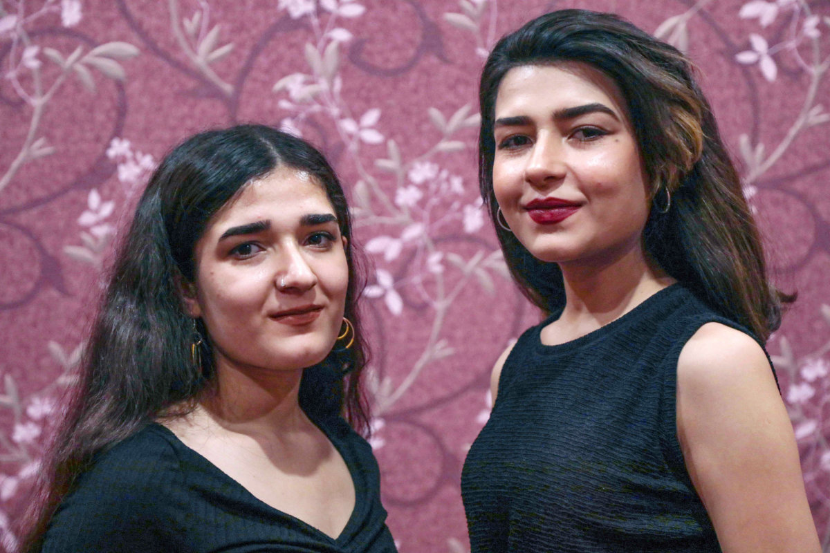 Syrian-Kurdish refugees and musicians Norshean Salih, 23, right, and her sister Perwin Salih, 20, in Irbil, the capital of the autonomous Kurdish region of northern Iraq. (AFP)