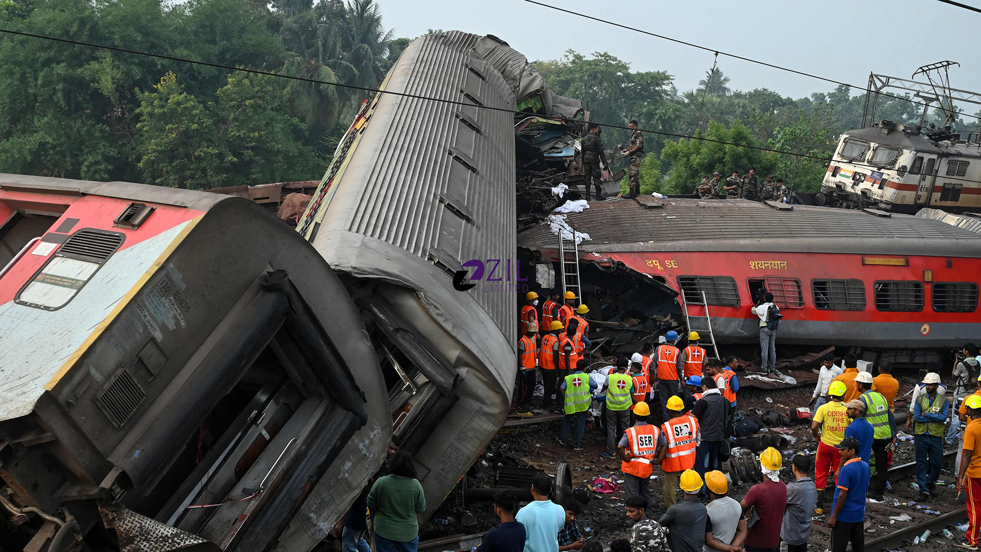 Rescue workers gather around damaged carriages at the accident site of a three-train collision near Balasore, about 200 km (125 miles) from the state capital Bhubaneswar in the eastern state of Odisha, on June 3, 2023. (AFP)
