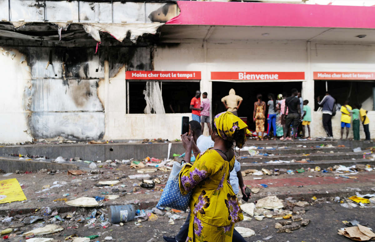 Streets filled with rubble and ransacked shops greeted residents of Dakar neighborhoods on Saturday. Violent protests have killed several people. (Reuters)