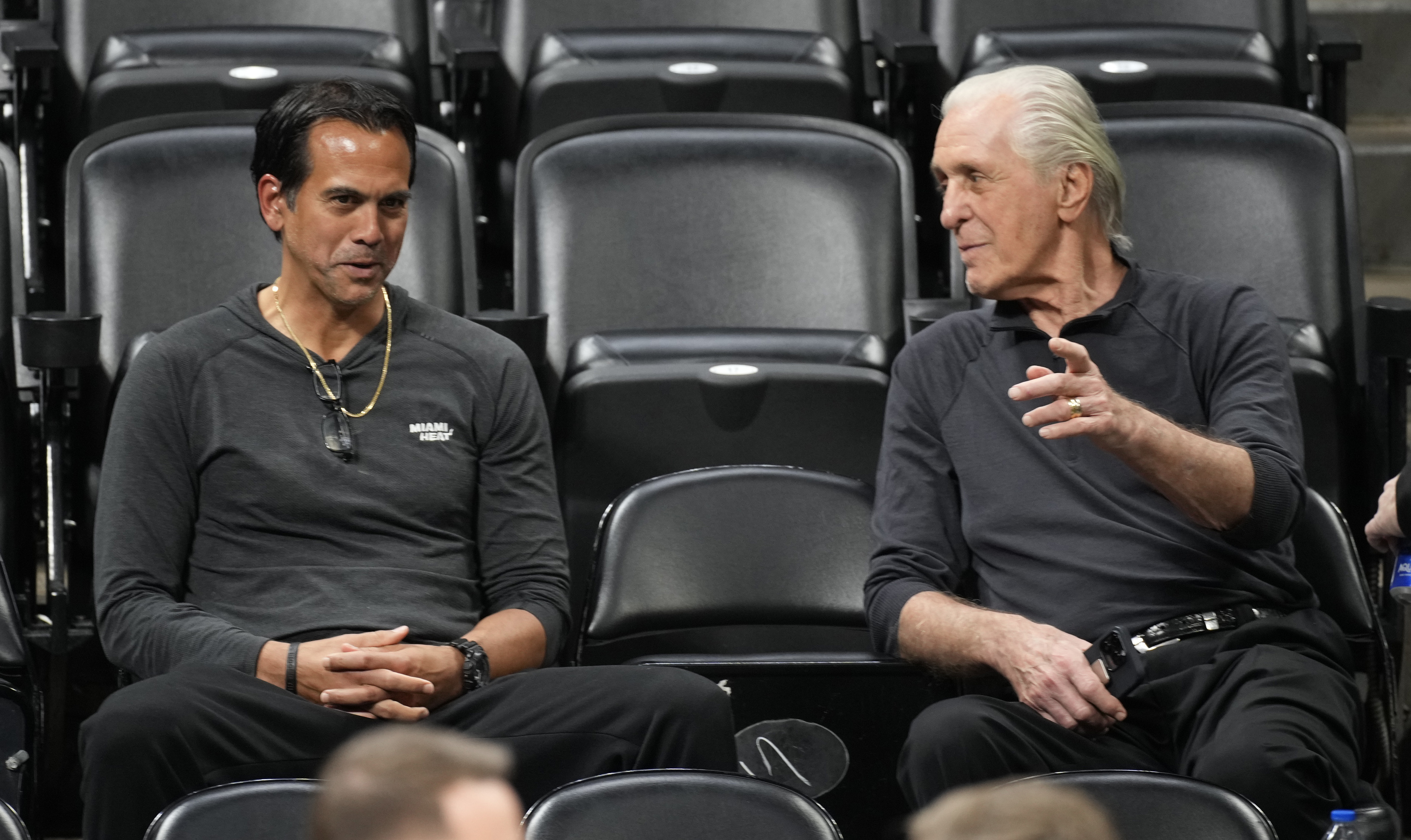 Miami Heat head coach Erik Spoelstra, left, chats with team president Pat Riley as they watch players practice for Game 2 of the NBA Finals, Saturday in Denver. (AP)