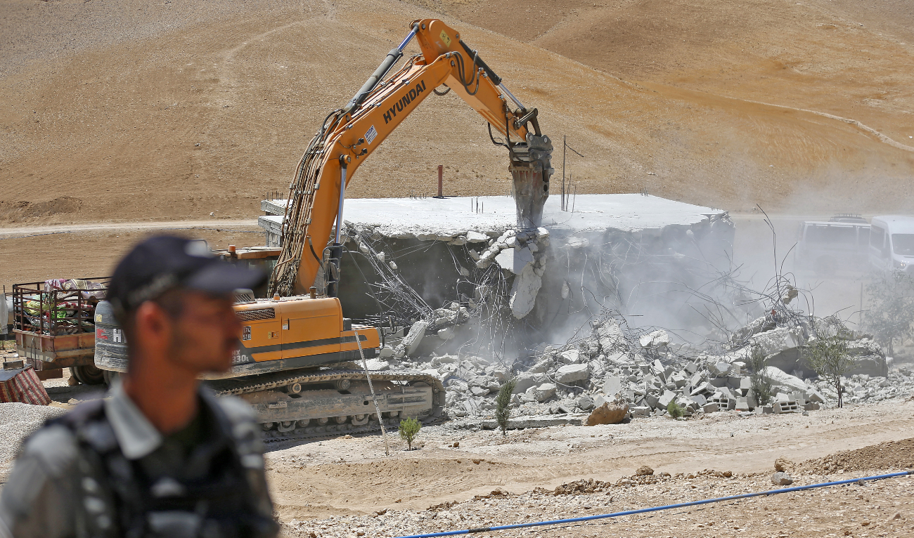 An Israeli bulldozer demolishes a Palestinian house in the Umm Qasas area of Masafer Yatta in the occupied West Bank on July 25, 2022. (AFP/File)