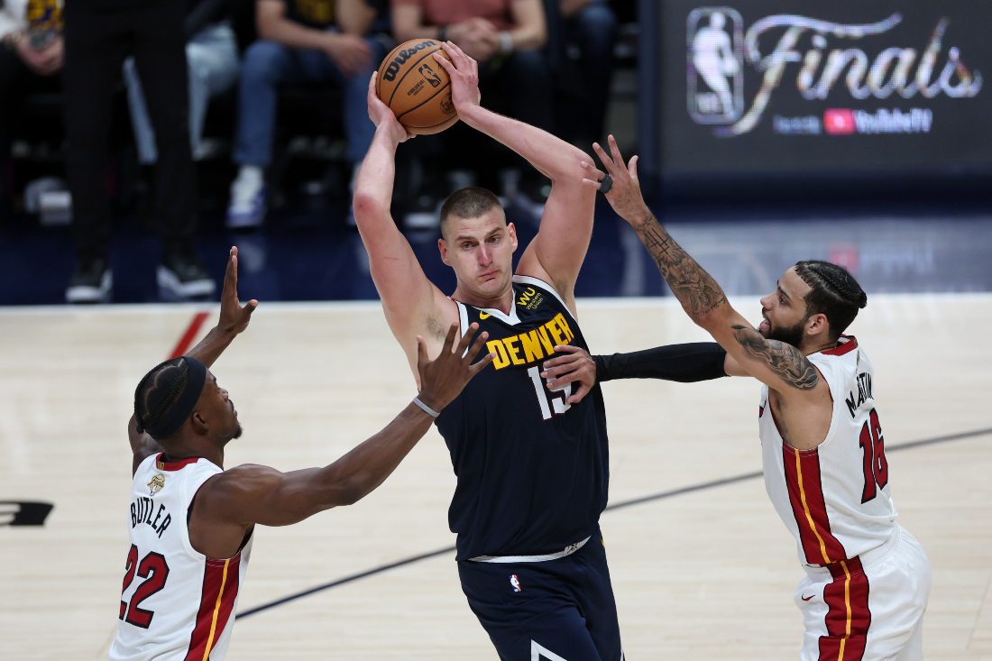 Nikola Jokic #15 of the Denver Nuggets looks to pass the ball, defended by Caleb Martin #16 and Jimmy Butler #22 of the Miami Heat during Game Two of the 2023 NBA Finals. (File/AFP)