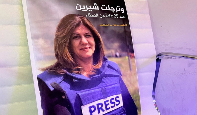 A picture of Al Jazeera reporter Shireen Abu Akleh, who was killed during an Israeli raid in Jenin, is displayed at the Al-Jazeera headquarters building in Doha, Qatar, May 11, 2022. (REUTERS)