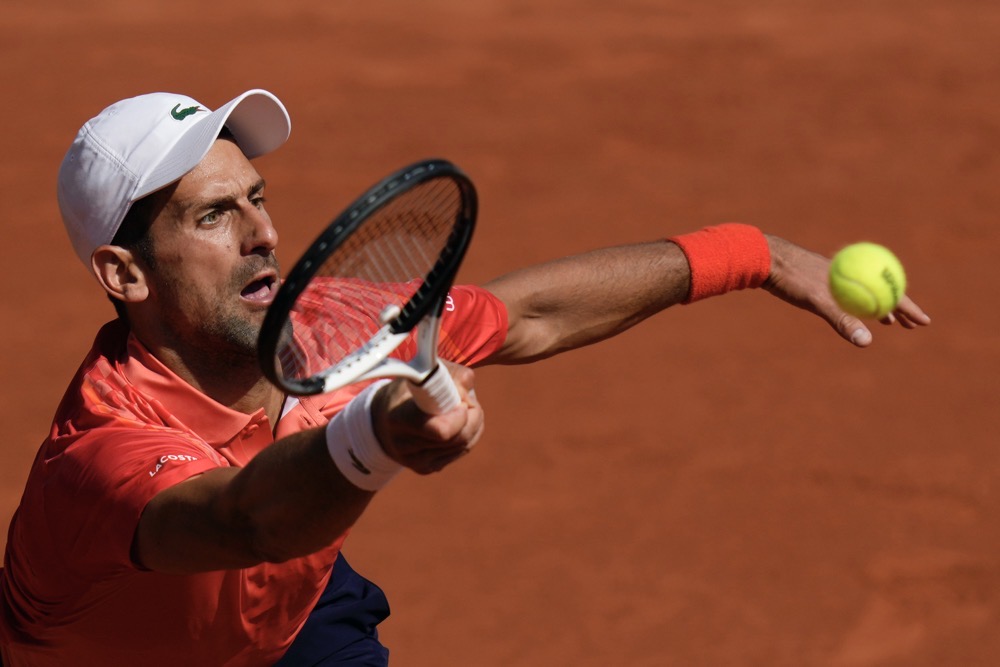 Serbia's Novak Djokovic plays a shot against Russia's Karen Khachanov during their quarter final match of the French Open tennis tournament at the Roland Garros stadium in Paris Tuesday. (AP)