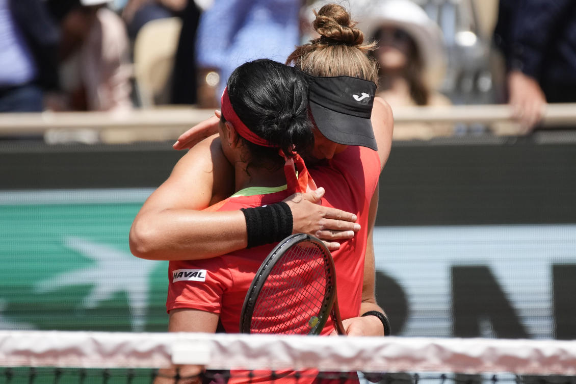 Tunisia’s Ons Jabeur congratulates Brazil’s Beatriz Haddad Maia with winning the quarterfinal match of the French Open in three sets, 3-6, 7-6 (7-5), 6-1, at the Roland Garros stadium in Paris on Jun. 7, 2023. (AP)