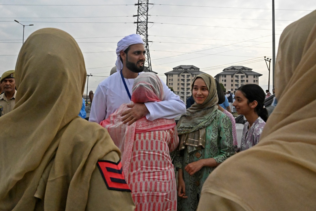 A pilgrim is embraced by his relative before leaving for the annual Hajj pilgrimage, in Srinagar on June 7, 2023. (AFP)