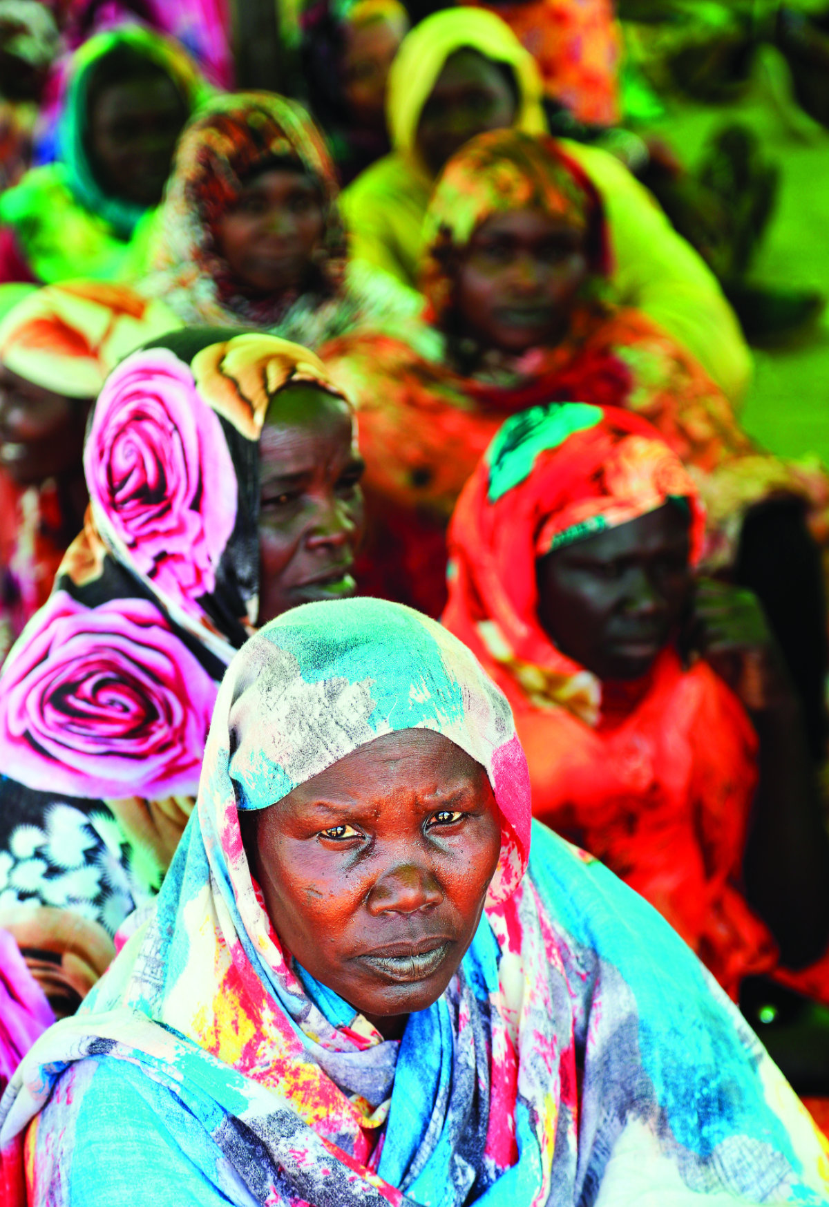 Women wait for aid to be distributed in South Darfur. (AFP)