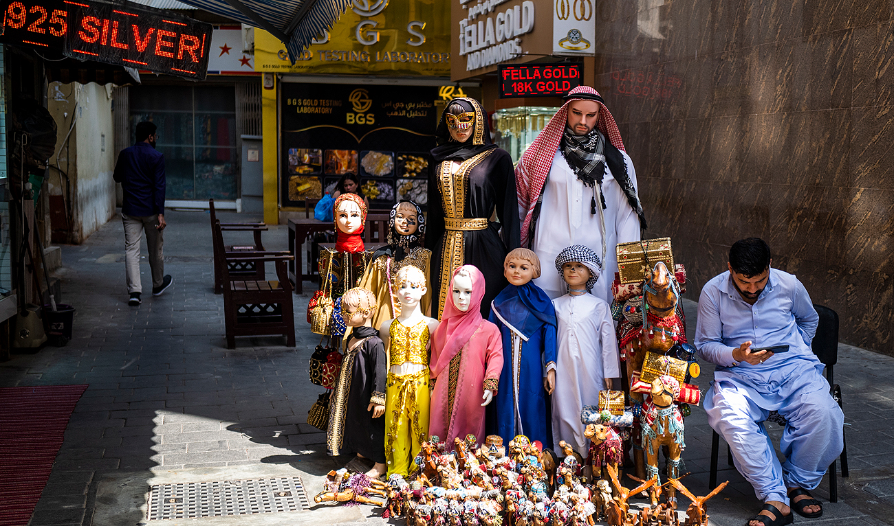 A vendor waits for customers at his store in a market area in Dubai on May 18, 2023. (Photo courtesy: AFP)